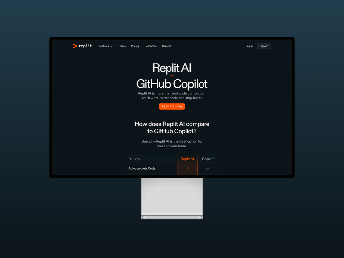 A monitor displaying the Replit AI Comparison marketing page on a navy blue gradient background